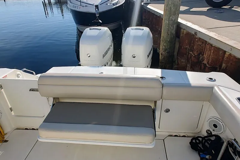 Slide: The Image of 2019 Boston Whaler 330 Outrage boat with twin Mercury engines at dock. - 10