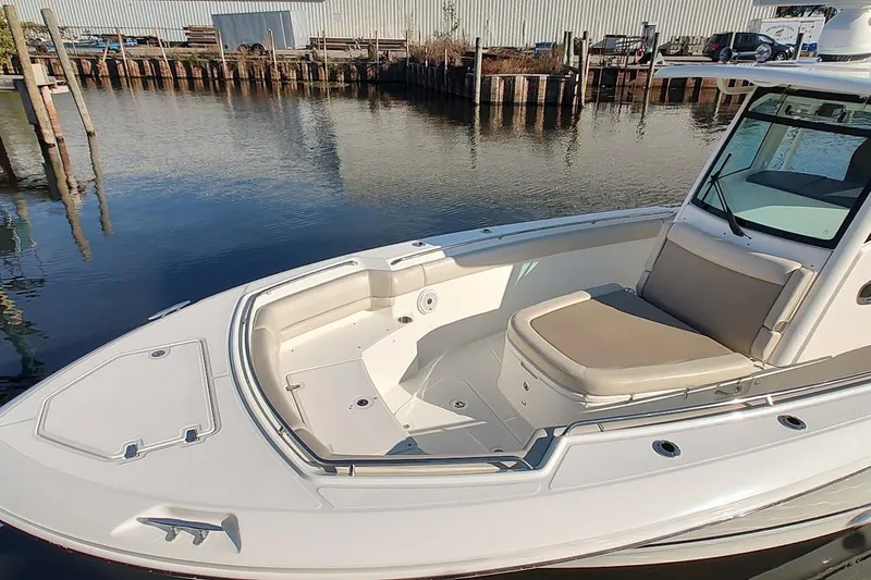 Slide: The Image of 2019 Boston Whaler 330 Outrage boat docked by calm waters. - 15