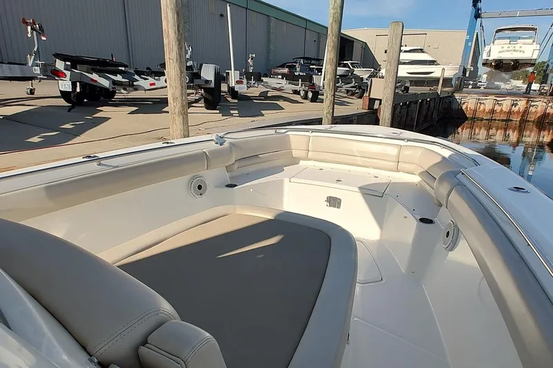 Slide: The Image of 2019 Boston Whaler 330 Outrage boat interior at marina with trailers and boats. - 16