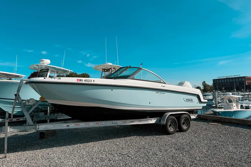 The Image of 2015 Boston Whaler 230 Vantage boat on trailer under clear blue sky. - 0