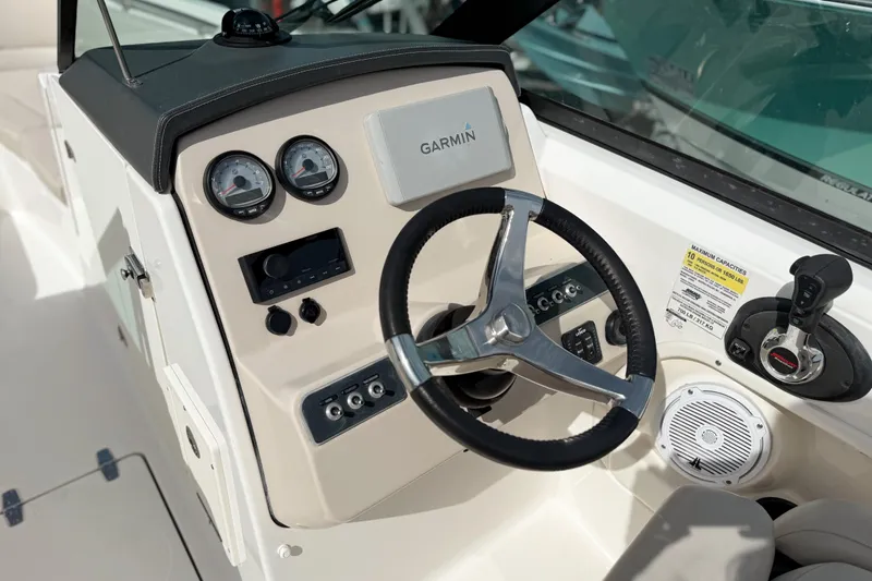 Slide: The Image of 2015 Boston Whaler 230 Vantage boat dashboard with Garmin navigation system and steering wheel. - 10