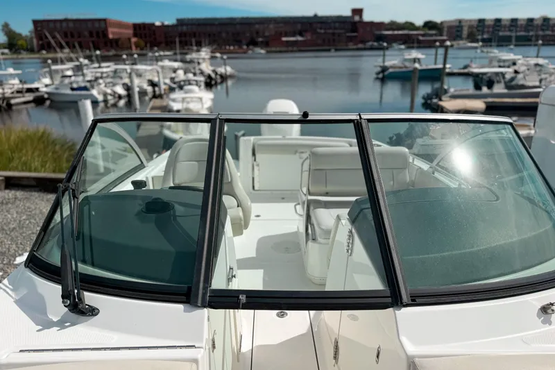 Slide: The Image of 2015 Boston Whaler 230 Vantage boat docked at a marina with waterfront view. - 13