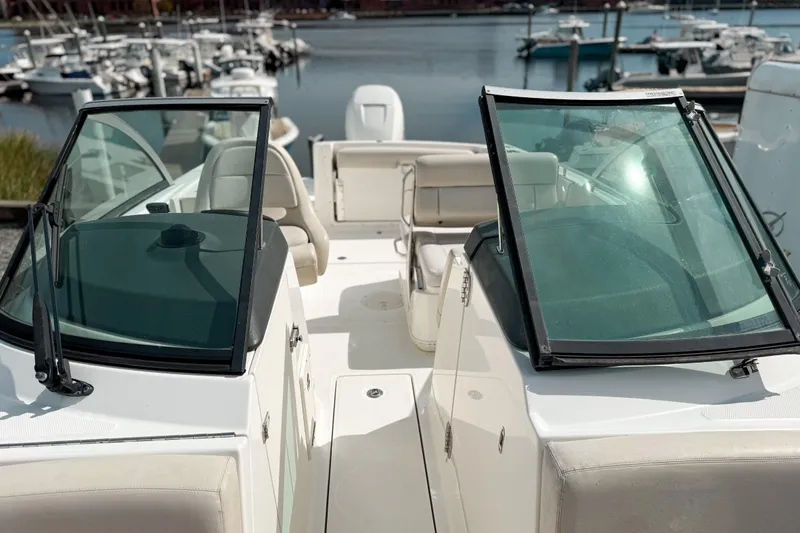 Slide: The Image of 2015 Boston Whaler 230 Vantage boat interior with dual windshields at marina. - 14