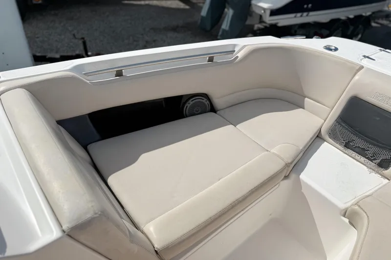 Slide: The Image of 2015 Boston Whaler 230 Vantage boat interior with cushioned seating area. - 16