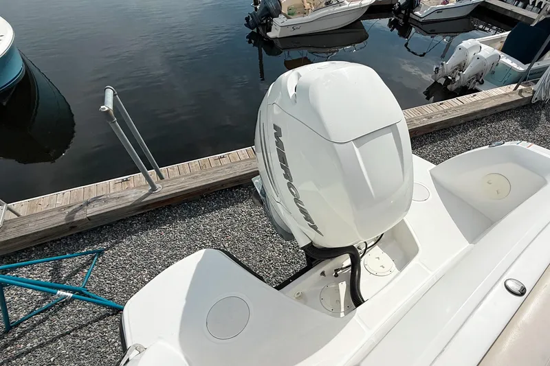 Slide: The Image of 2015 Boston Whaler 230 Vantage with Mercury outboard engine at dockside. - 2