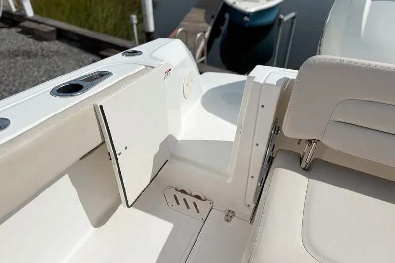 Slide: The Image of 2015 Boston Whaler 230 Vantage boat interior with seating and storage compartment. - 4