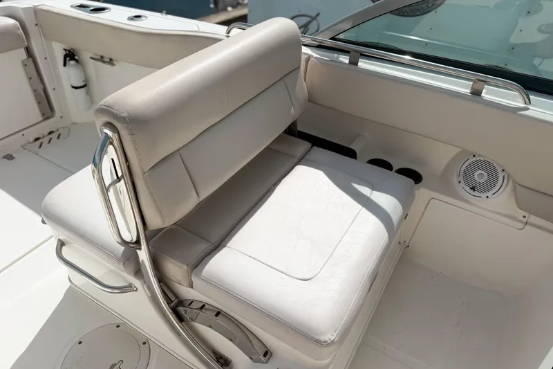 Slide: The Image of 2015 Boston Whaler 230 Vantage boat interior with cushioned seating and stainless steel accents. - 7