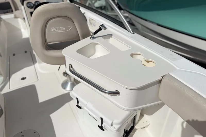 Slide: The Image of 2015 Boston Whaler 230 Vantage boat interior with seating and storage features. - 8