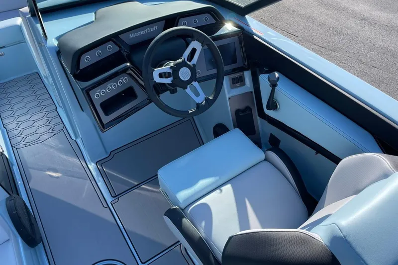 Slide: The Image of 2025 MasterCraft NXT22 boat interior with modern steering and controls. - 12