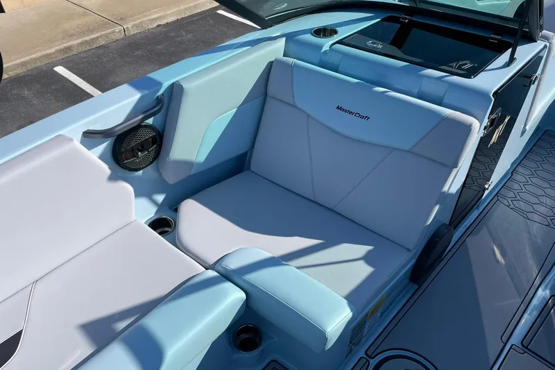 Slide: The Image of 2025 MasterCraft NXT22 boat interior with light blue seating and speaker. - 13