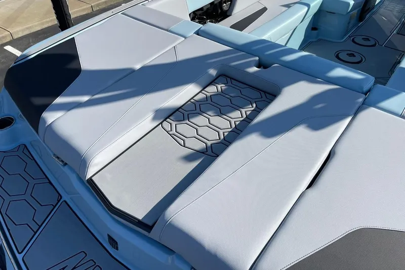 Slide: The Image of 2025 MasterCraft NXT22 boat interior with hexagonal pattern seating and sleek design. - 15