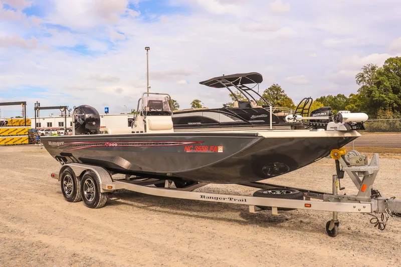 The Image of 2022 Ranger RB200 boat on trailer, parked outdoors under a cloudy sky. - 0
