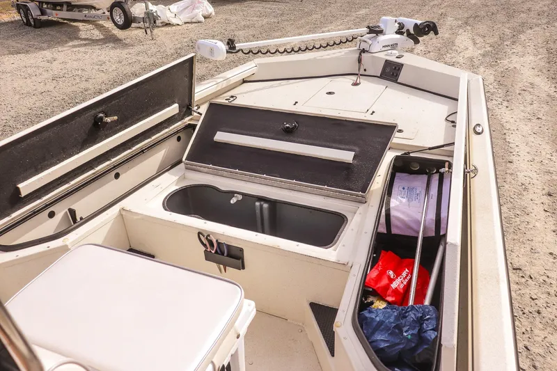 Slide: The Image of 2022 Ranger RB200 boat interior with storage compartments and fishing gear. - 12