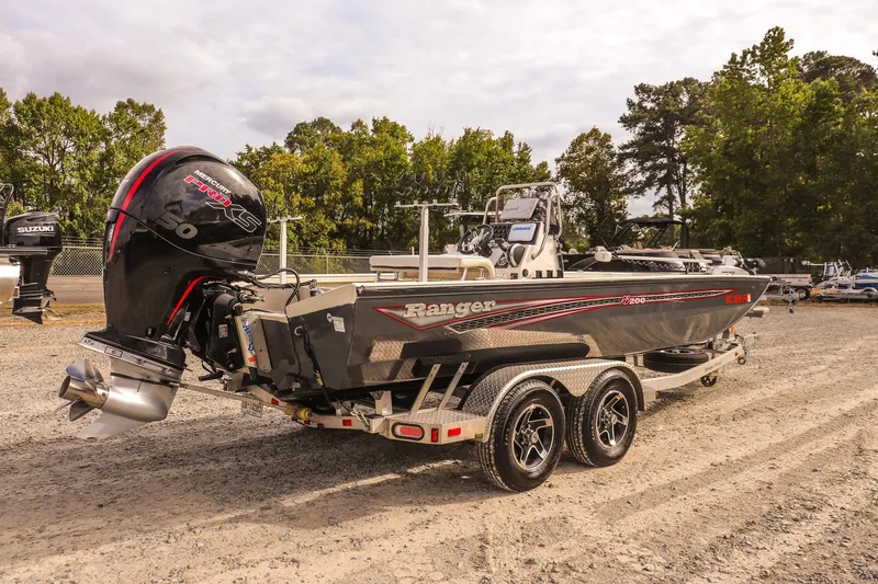 Slide: The Image of 2022 Ranger RB200 boat with Mercury engine on a trailer, parked outdoors. - 6