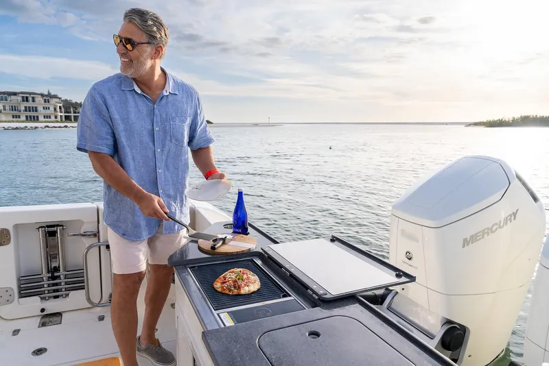 Slide: The Image of Manufacturer Provided Image: 2026 Boston Whaler 365 Conquest boat with cushioned deck, sleek design, and ocean backdrop. - 14