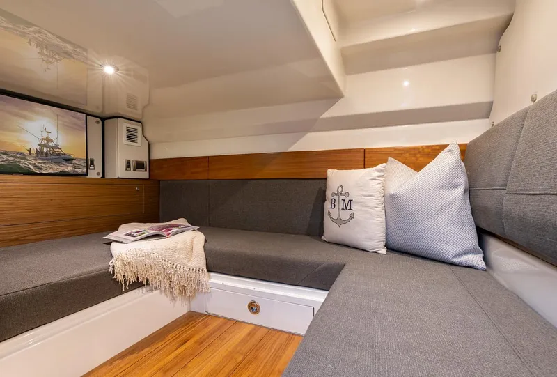 Slide: The Image of Manufacturer Provided Image: Interior of 2026 Boston Whaler 365 Conquest, featuring cozy seating and nautical decor. - 29