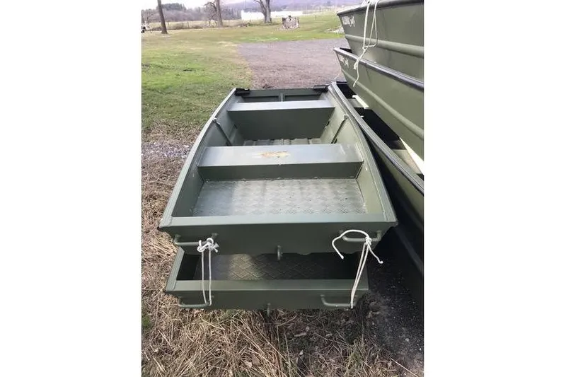 The Image of 2022 Alumacraft 1032 Jon boat on grass, side view, green color. - 1