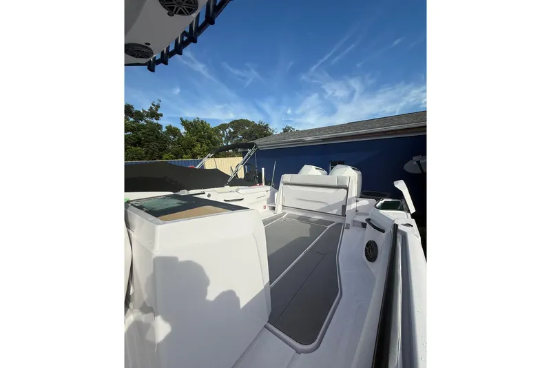Slide: The Image of 2025 Axopar 29 CCX boat deck with seating, under clear blue sky. - 3