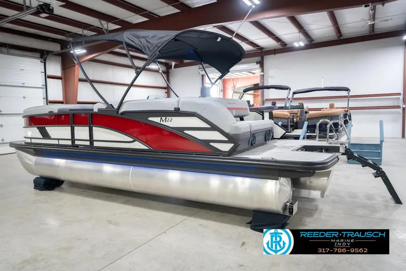 Slide: The Image of 2026 Bennington 22 ML pontoon boat in showroom with canopy and sleek design. - 10