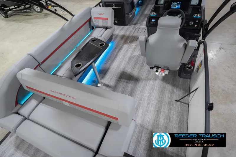 Slide: The Image of 2026 Bennington 22 ML boat interior with gray seating and blue LED lighting. - 14