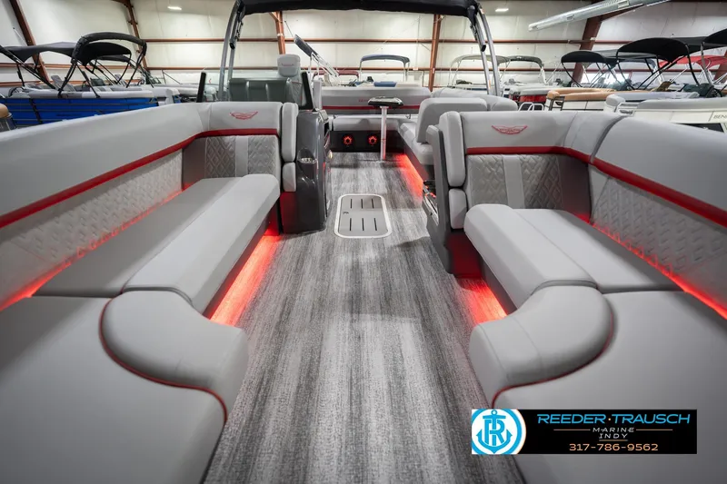 Slide: The Image of 2026 Bennington 22 ML pontoon boat interior with gray seating and red LED lighting. - 16
