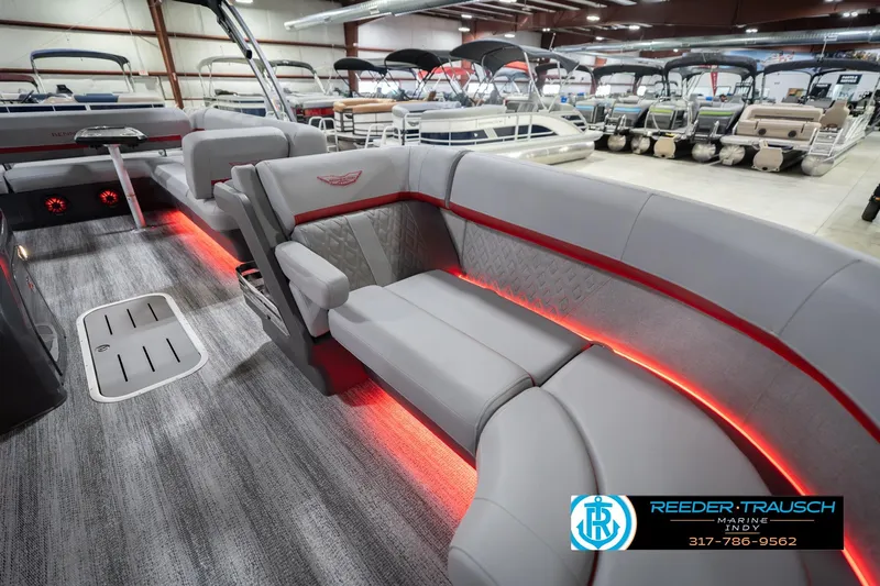 Slide: The Image of 2026 Bennington 22 ML pontoon boat interior with red LED lighting and luxurious seating. - 23