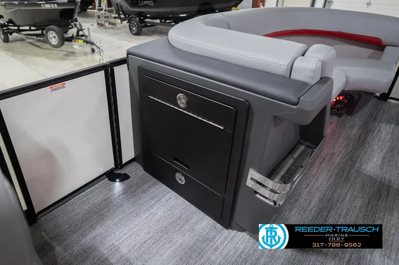 Slide: The Image of 2026 Bennington 22 ML boat interior with gray seating and storage compartment. - 26