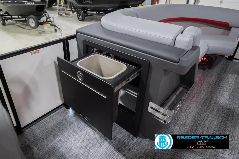 Slide: The Image of 2026 Bennington 22 ML boat interior with open storage compartment and seating. - 27