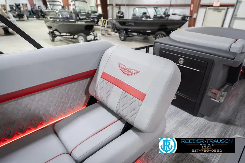 Slide: The Image of 2026 Bennington 22 ML boat interior with gray and red seating, showroom display. - 31