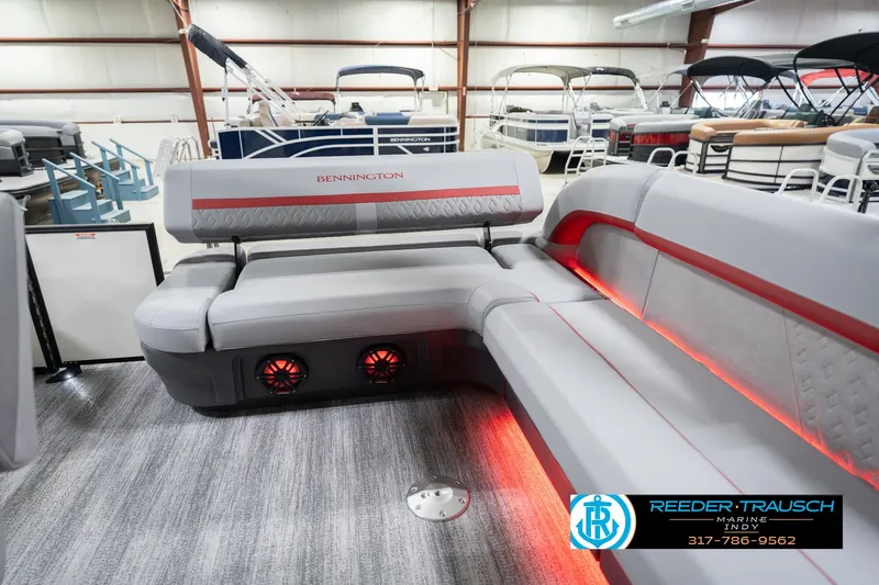 Slide: The Image of 2026 Bennington 22 ML pontoon boat interior with gray seating and red LED lighting. - 35