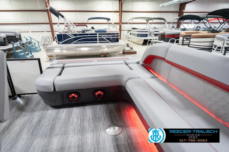 Slide: The Image of 2026 Bennington 22 ML pontoon boat interior with red LED lighting and luxurious seating. - 36