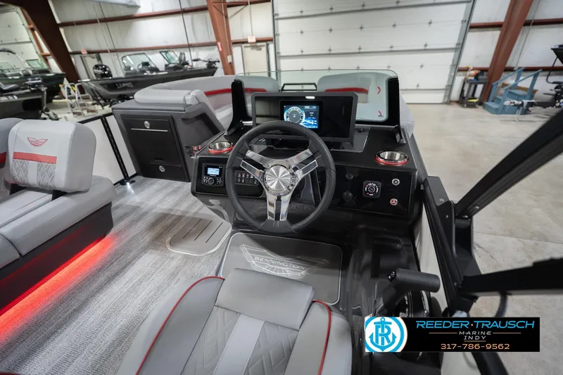 Slide: The Image of 2026 Bennington 22 ML boat interior with modern steering console and seating in showroom. - 37