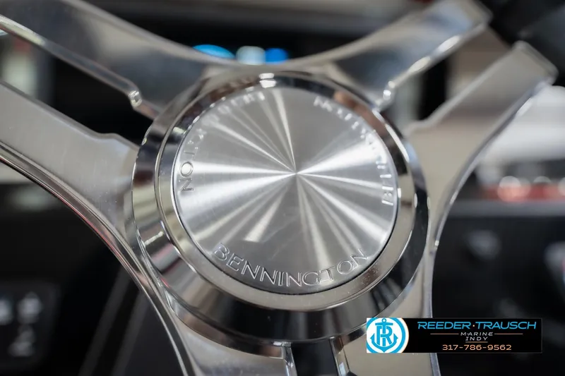 Slide: The Image of Close-up of a 2026 Bennington 22 ML steering wheel with Reeder-Trausch Marine logo. - 39