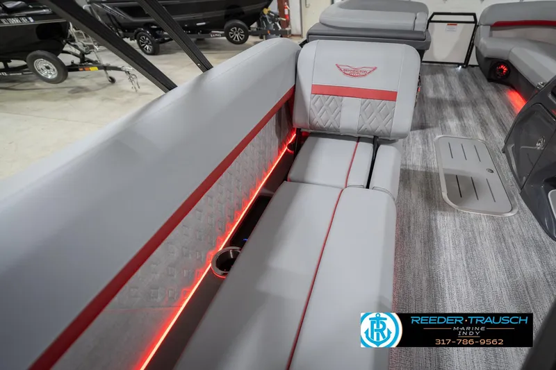 Slide: The Image of 2026 Bennington 22 ML boat interior with gray seating, red accents, and ambient lighting. - 48