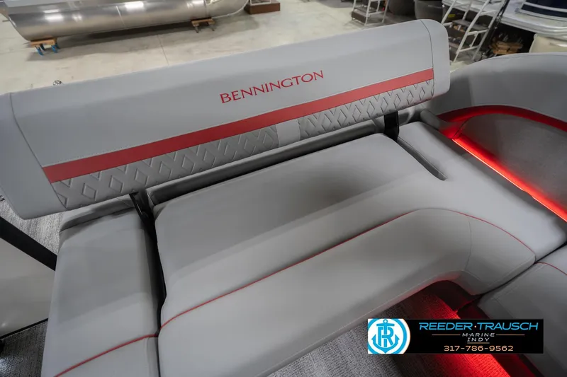 Slide: The Image of 2026 Bennington 22 ML boat interior with gray and red seating, Reeder-Trausch Marine logo. - 49