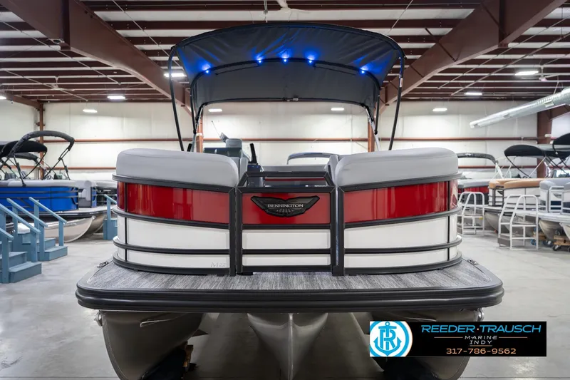 Slide: The Image of 2026 Bennington 22 ML pontoon boat in showroom with canopy and modern design. - 5