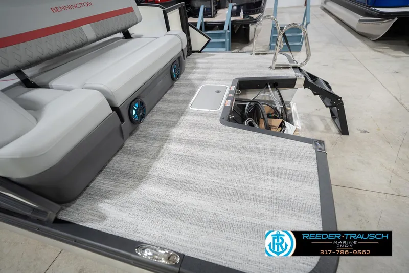 Slide: The Image of 2026 Bennington 22 ML boat interior with seating, speakers, and storage compartment. - 57