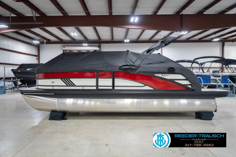 Slide: The Image of 2026 Bennington 22 ML pontoon boat with cover in indoor showroom. - 58