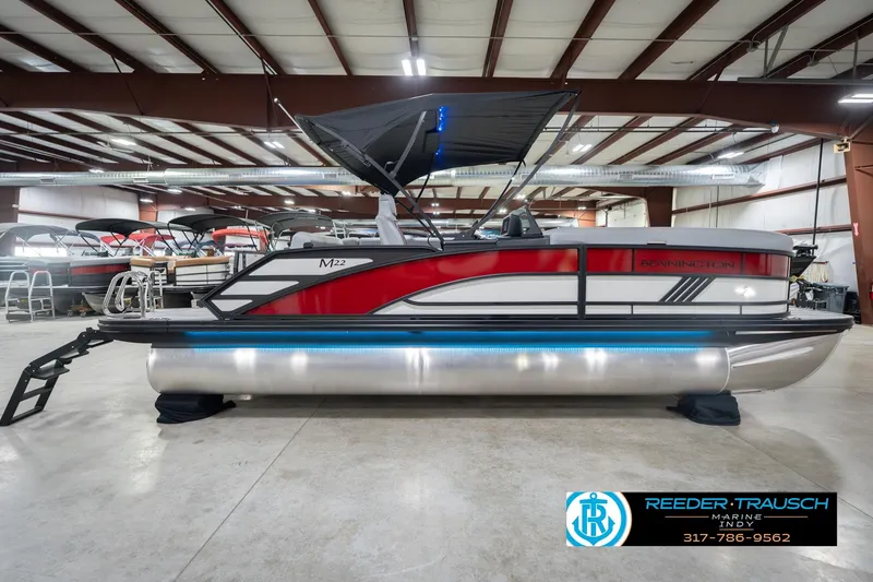 Slide: The Image of 2026 Bennington 22 ML pontoon boat in showroom with sleek design and modern features. - 7