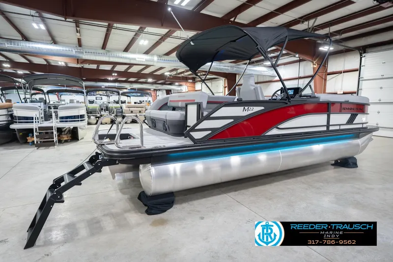 Slide: The Image of 2026 Bennington 22 ML pontoon boat in showroom with sleek design and canopy. - 8