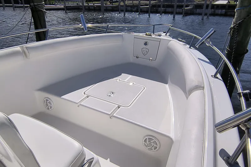 Slide: The Image of 2003 Century 2600 Center Console boat interior with seating and storage. - 12