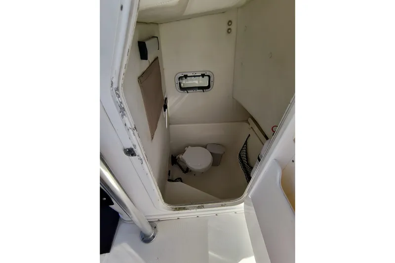 Slide: The Image of 2003 Century 2600 Center Console boat interior with compact marine toilet. - 14