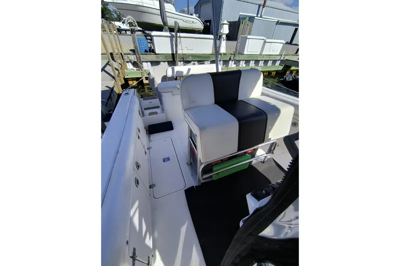 Slide: The Image of 2003 Century 2600 Center Console boat interior with seating and storage compartments. - 6