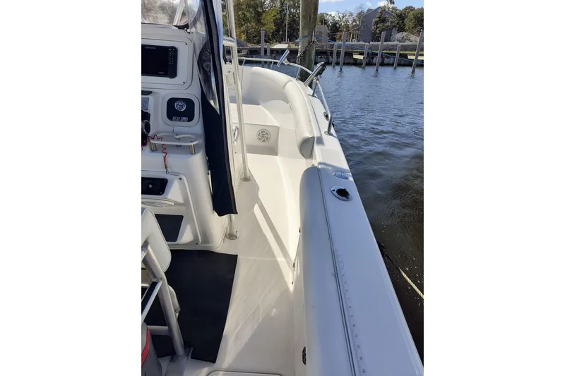 Slide: The Image of 2003 Century 2600 Center Console boat docked by the water. - 9