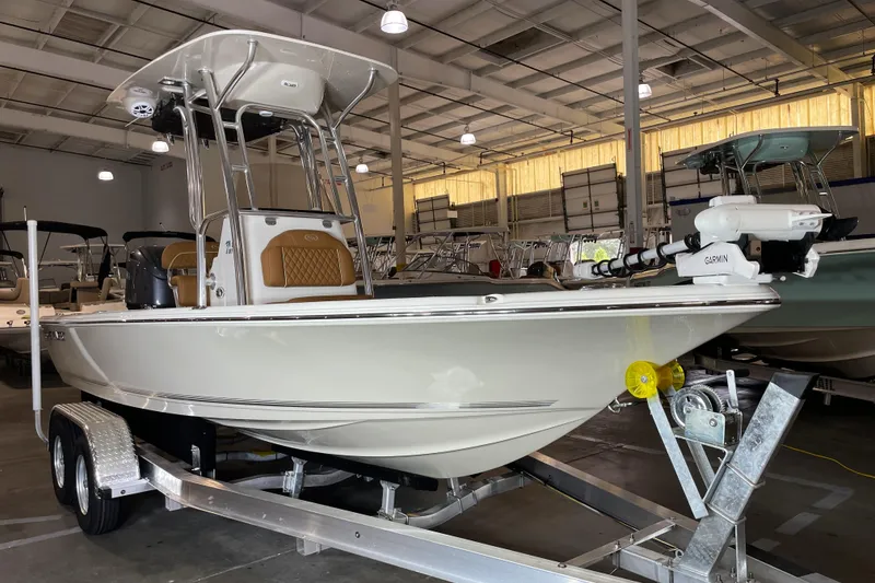 The Image of 2026 Key West 210 Bay Reef boat in indoor showroom on trailer. - 0