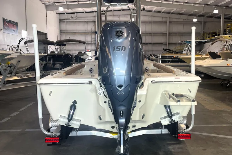 Slide: The Image of 2026 Key West 210 Bay Reef boat with powerful outboard motor in showroom. - 10