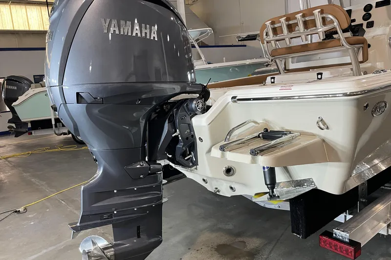 Slide: The Image of 2026 Key West 210 Bay Reef boat with Yamaha outboard motor in showroom. - 13