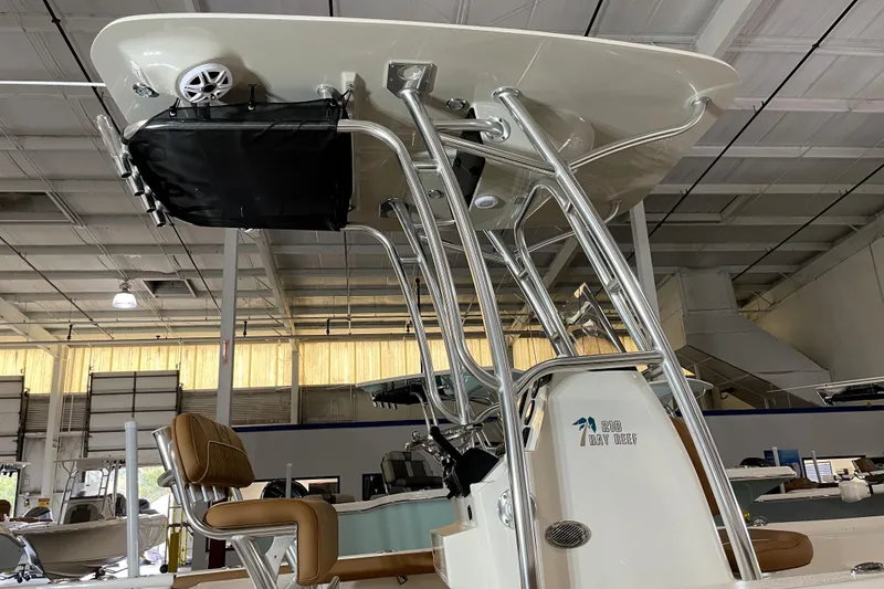 Slide: The Image of 2026 Key West 210 Bay Reef boat interior with T-top and seating in a showroom. - 15