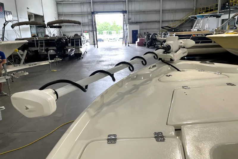 Slide: The Image of 2026 Key West 210 Bay Reef boat with mounted equipment in a showroom. - 17