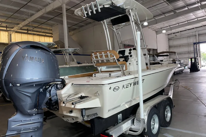 Slide: The Image of 2026 Key West 210 Bay Reef boat with Yamaha engine in a warehouse. - 2